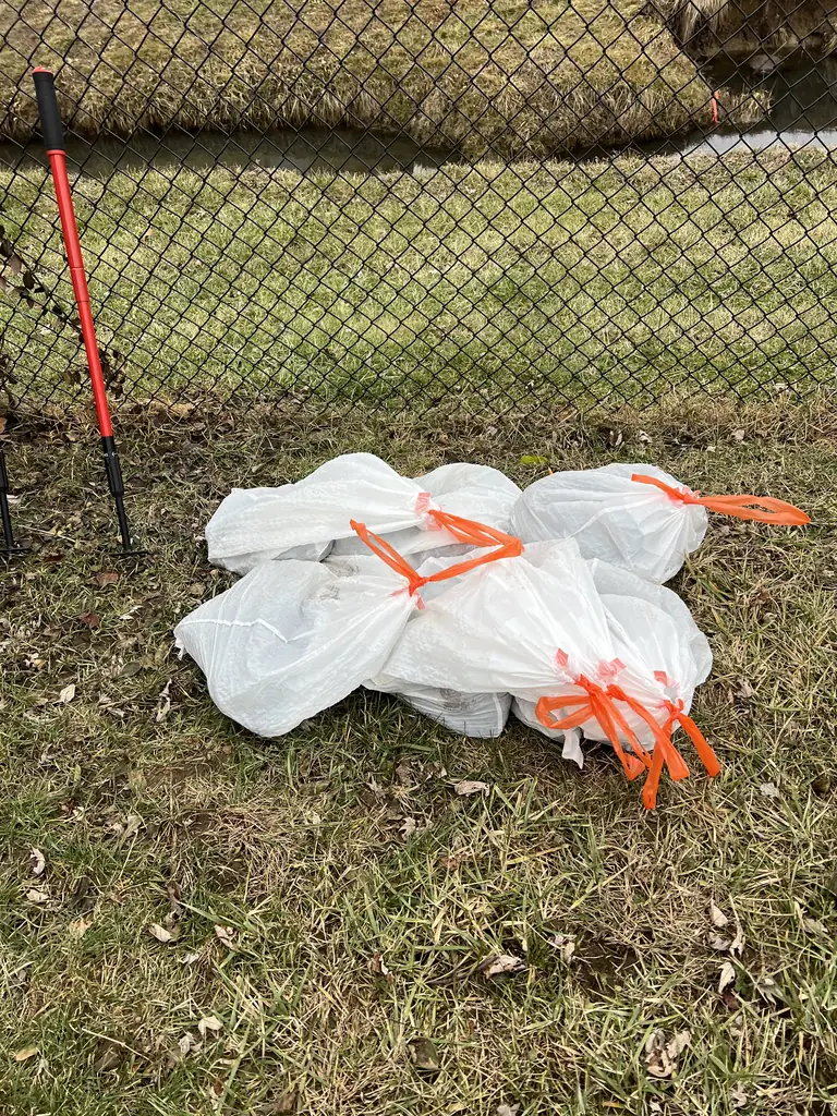 Real visit photo: tied bags of collected dog waste ready to be hauled away.